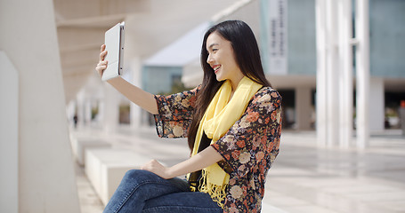 Image showing Woman taking a self portrait with tablet