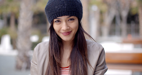 Image showing Pretty thoughtful young woman in a woolly cap