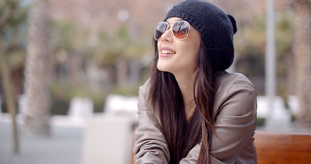 Image showing Gorgeous young woman sitting daydreaming