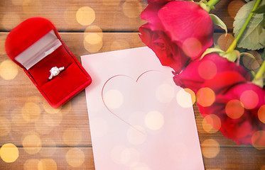 Image showing close up of diamond ring, roses and greeting card