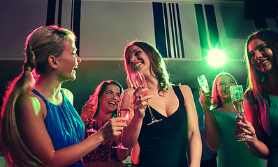 Image showing young women with glasses of champagne in club