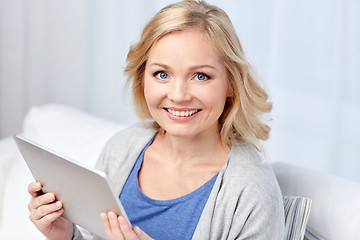 Image showing happy middle aged woman with tablet pc at home