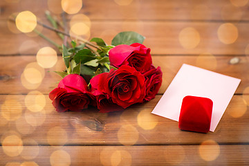 Image showing close up of gift box, red roses and greeting card