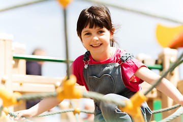 Image showing happy little girl climbing on children playground