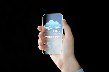 Image showing close up of hand with weather app on smartphone