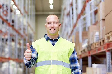 Image showing happy man showing thumbs up gesture at warehouse