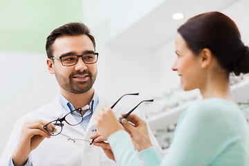 Image showing woman and optician showing glasses at optics store