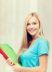 Image showing smiling student with folders