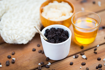 Image showing close up of coffee scrub in cup and honey on wood