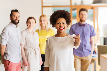 Image showing woman pointing to you over creative office team