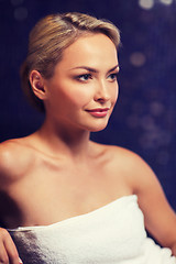 Image showing beautiful young woman sitting in bath towel