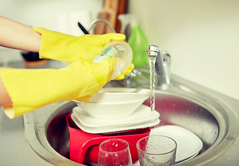 Image showing close up of woman hands washing dishes in kitchen