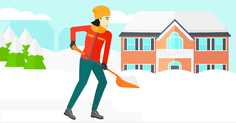 Image showing Woman shoveling and removing snow.