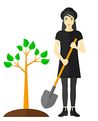 Image showing Woman plants tree.