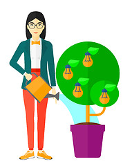 Image showing Woman watering tree with light bulbs.