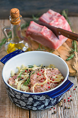 Image showing Pork chops in a pan on the old table.