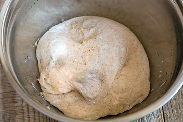 Image showing Homemade bread dough in a metal bowl.