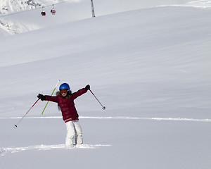 Image showing Happy girl on off-piste slope after snowfall at nice sun day