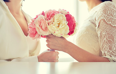 Image showing close up of happy lesbian couple with flowers