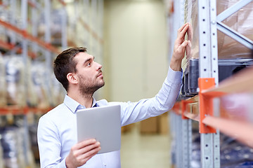 Image showing businessman with tablet pc at warehouse