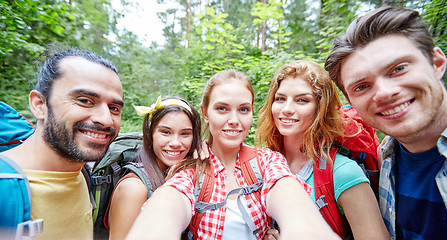 Image showing friends with backpack taking selfie in wood