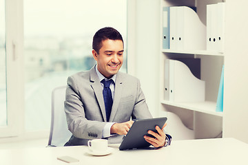Image showing smiling businessman with tablet pc and coffee cup