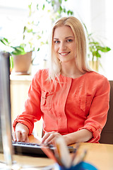 Image showing happy business woman with computer at office