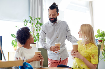 Image showing happy creative team drinking coffee in office