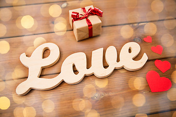 Image showing close up of word love with gift box and red hearts