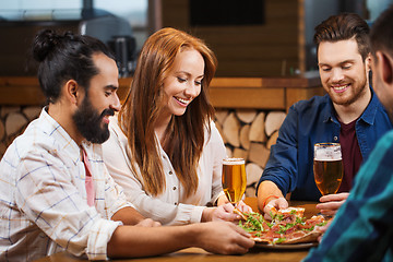 Image showing friends sharing pizza with beer at pizzeria