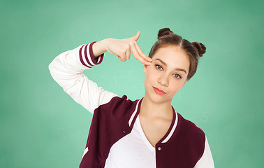 Image showing bored student girl making finger gun gesture