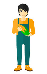 Image showing Farmer holding corn.