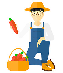 Image showing Farmer collecting carrots.