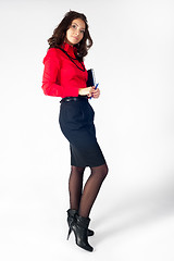 Image showing Pretty businesswoman standing with organizer diary