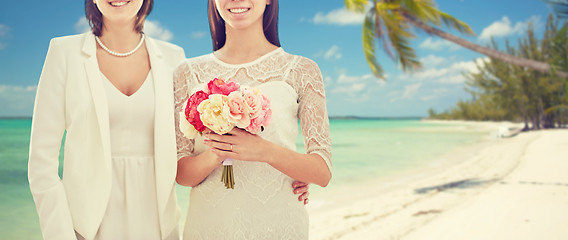 Image showing close up of happy lesbian couple with flowers