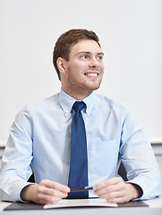 Image showing smiling businessman sitting in office