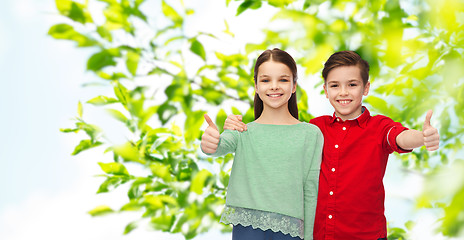 Image showing happy boy and girl showing thumbs up