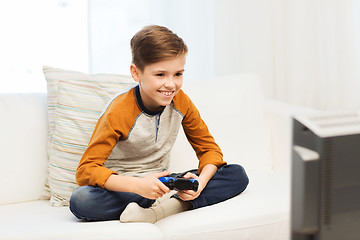 Image showing happy boy with joystick playing video game at home