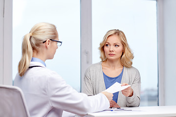 Image showing doctor giving prescription to woman at hospital