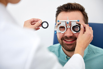 Image showing optician with trial frame and patient at clinic