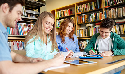 Image showing happy students with tablet pc in library