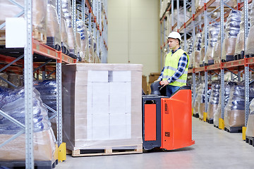 Image showing man on forklift loading boxes at warehouse