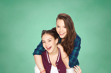 Image showing happy teenage girls having fun over green board