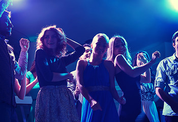 Image showing group of happy friends dancing in night club