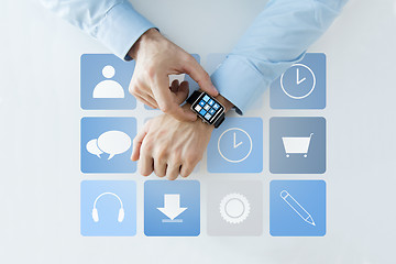 Image showing hands with application icons on smart watch