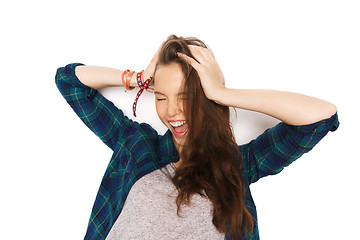 Image showing happy pretty teenage girl holding to head