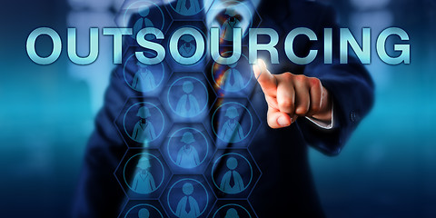 Image showing Manager Touching OUTSOURCING Onscreen