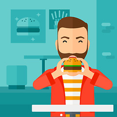 Image showing Man eating hamburger. 