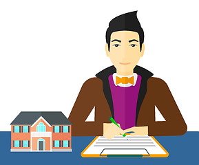 Image showing Real estate agent signing contract.