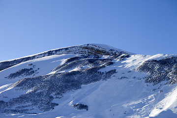 Image showing Snowy mountains with track from avalanche after snowfall